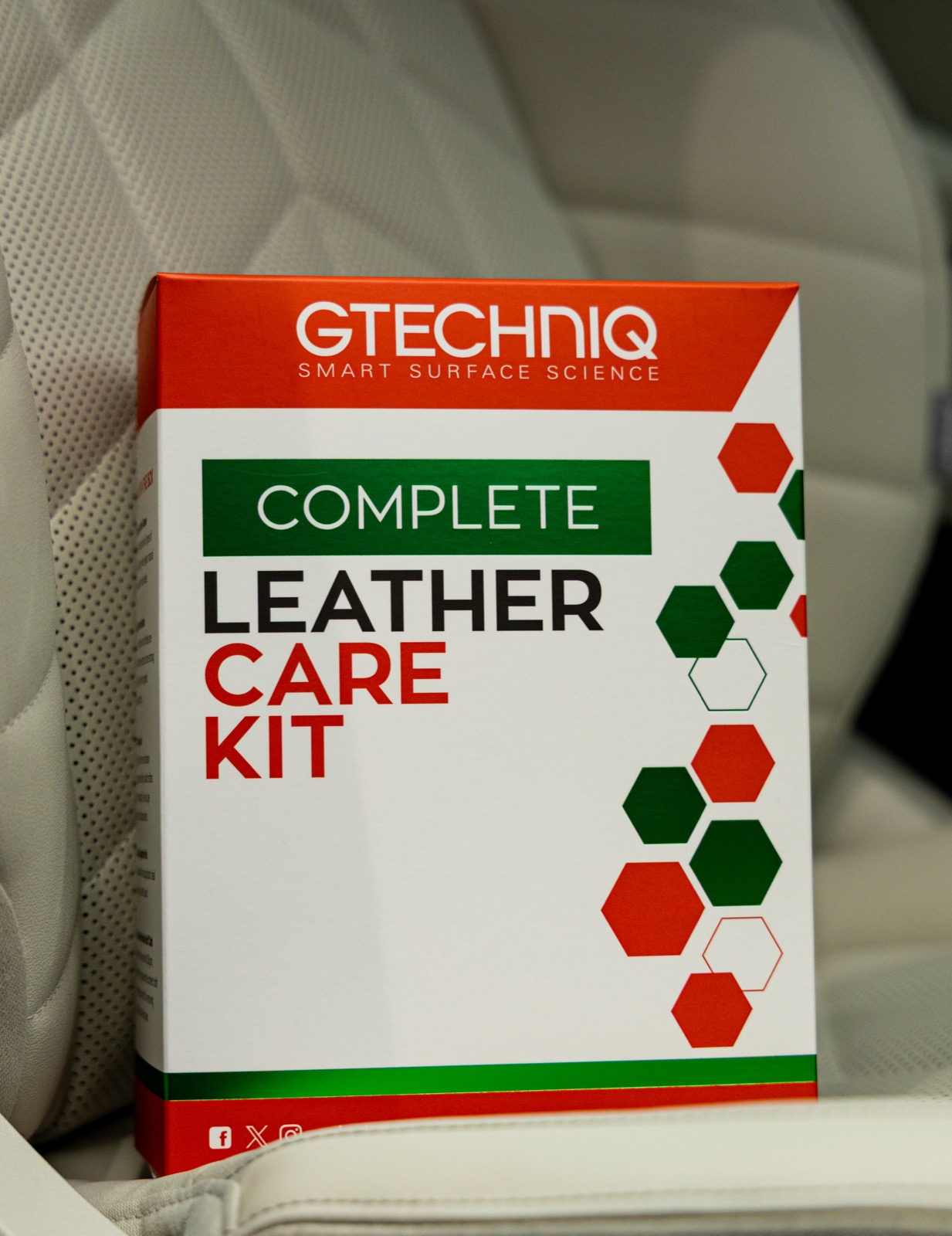 Gtechniq Complete Leather Care Kit packaging on an automotive leather seat